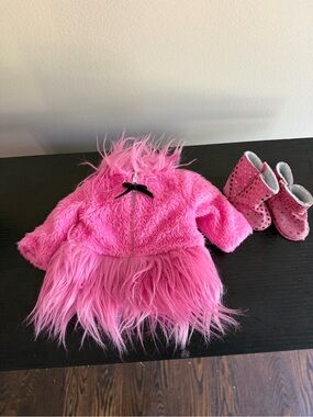 Sophia pink faux-fur jacket with a black bow detail and pink sequin boots